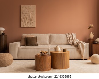 Aesthetic composition of living room interior with mock up poster frame, modular sofa, wooden coffee table, vase with dried flowers, pillows, armchair and personal accessories. Home decor. Template.  Stock fotografie