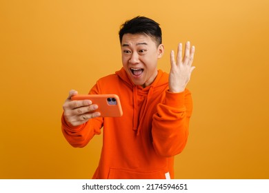 Asian Man Is Playing Mobile Game Seriously. Stock Photo, Picture
