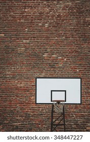 Basketball court outdoor in front of a old brick wall. Toned photo. Stock Photo