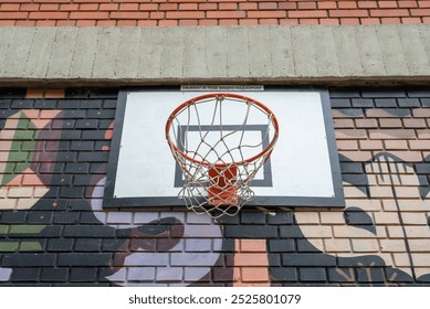 Belgrade, Serbia. May 4th 2024. Basketball hoop on the exterior of the Faculty of Dramatic Arts in New Belgrade, with a sign stating the facility is under video surveillance.   Editorial Stock Photo
