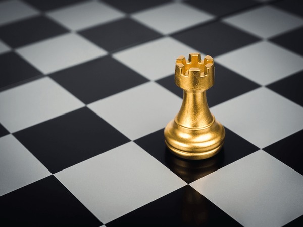 Premium Photo  Closeup of chess pieces on the chessboard under the lights  with a blurry background