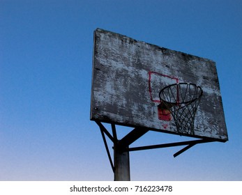 Looking up at a worn down basketball goal. Stock Photo
