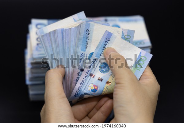 A pile of one thousand Philippines banknotes. Cash of Thousand