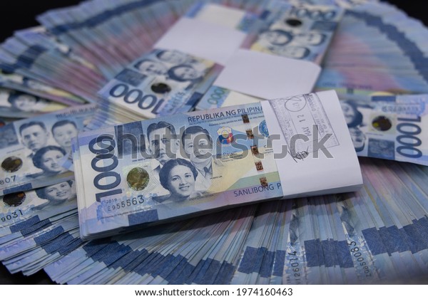 A pile of one thousand Philippines banknotes. Cash of Thousand