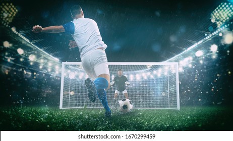 Стоковая фотография: Soccer scene at night match with player in a white and blue uniform kicking the penalty kick