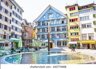 ZURICH, SWITZERLAND - APRIL 12, 2017: Munsterhof square with fountain and colorful buildings with cafe and restaurants in the old town of Zurich city in Switzerland Editorial Stock Photo